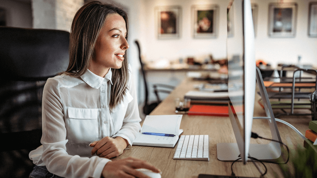 Paralegal smiling at computer